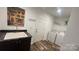 A bright laundry room features a utility sink, wood-look flooring, and a washer and dryer at 312 Sailwinds Rd, Mooresville, NC 28115