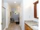 Bright bathroom featuring dual sink vanity, shower, tile flooring and a large mirror at 3199 Harmony Rd, Catawba, SC 29704