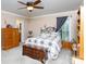 Cozy bedroom with carpet flooring, large window, ceiling fan, and wooden accents at 3199 Harmony Rd, Catawba, SC 29704