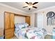 Bedroom with carpet, ceiling fan, large window, and built-in wooden storage at 3199 Harmony Rd, Catawba, SC 29704