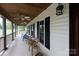 Relaxing front porch with a wood ceiling, fan, and seating at 3199 Harmony Rd, Catawba, SC 29704