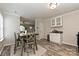 Kitchen and dining area featuring granite countertops, white cabinets and stainless steel appliances and wood floors at 407 French St, Charlotte, NC 28216