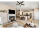 Open-concept living space with fireplace flowing into dining area and kitchen with bar seating at 418 Garnet Ct, Fort Mill, SC 29708