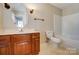 Neutral bathroom featuring a wood vanity, white countertops, and a shower-tub combo at 4427 Brandie Glen Rd, Charlotte, NC 28269