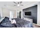 Modern bedroom boasts a stylish accent wall and a ceiling fan at 4427 Brandie Glen Rd, Charlotte, NC 28269