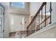 Bright foyer with a staircase, light-colored walls, and wood-look floors at 4427 Brandie Glen Rd, Charlotte, NC 28269