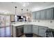 Charming kitchen featuring gray cabinets, pendant lighting, stainless steel appliances, and hardwood floors at 4427 Brandie Glen Rd, Charlotte, NC 28269