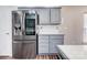 The kitchen features stainless steel appliances, gray cabinets, modern fixtures, and beautiful hardwood floors at 4427 Brandie Glen Rd, Charlotte, NC 28269