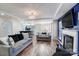 Open-concept living room with a fireplace and view into kitchen with bar seating at 4427 Brandie Glen Rd, Charlotte, NC 28269