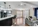Modern living space flowing into a kitchen with bar seating and French doors at 4427 Brandie Glen Rd, Charlotte, NC 28269