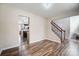 Bright living room with wood floors leading to the kitchen and staircase at 4427 Brandie Glen Rd, Charlotte, NC 28269