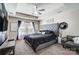 Stylish main bedroom with tray ceilings, a ceiling fan, natural light, and a flat-screen TV at 4427 Brandie Glen Rd, Charlotte, NC 28269