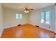 Bedroom with hardwood floors, ceiling fan and natural light from two windows at 4800 Kipling Dr, Charlotte, NC 28212