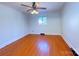 Neutral bedroom with hardwood floors, white walls and a ceiling fan at 4800 Kipling Dr, Charlotte, NC 28212