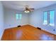Bedroom with hardwood floors, ceiling fan and natural light from two windows at 4800 Kipling Dr, Charlotte, NC 28212