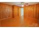 Bedroom with hardwood floors, wood walls and a ceiling fan at 4800 Kipling Dr, Charlotte, NC 28212