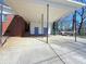 Large covered carport with brick and siding details adds functionality to the home's exterior at 4800 Kipling Dr, Charlotte, NC 28212