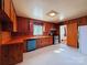 Practical kitchen featuring wood cabinets, laminate countertops, and durable flooring at 4800 Kipling Dr, Charlotte, NC 28212