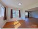 Inviting room with hardwood floors, and large windows providing plenty of natural light at 4800 Kipling Dr, Charlotte, NC 28212