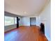 Bright living room with hardwood floors, a fireplace, and large windows providing plenty of natural light at 4800 Kipling Dr, Charlotte, NC 28212