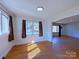 Inviting room with hardwood floors, and large windows providing plenty of natural light at 4800 Kipling Dr, Charlotte, NC 28212