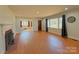 Spacious open-concept living area with hardwood floors, fireplace, large windows and easy access to other rooms at 4800 Kipling Dr, Charlotte, NC 28212