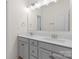 Bathroom showcasing a double sink vanity, neutral paint, tile flooring and brushed nickel fixtures at 491 Creevy Nw Dr, Concord, NC 28027