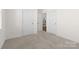 A bright bedroom with neutral carpeting and ample closet space at 491 Creevy Nw Dr, Concord, NC 28027