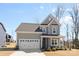 Charming two-story home with a two-car garage and welcoming front porch in a serene neighborhood at 491 Creevy Nw Dr, Concord, NC 28027