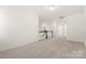 Upstairs hallway with staircase, carpet, and neutral colored walls at 491 Creevy Nw Dr, Concord, NC 28027
