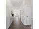 Elegant hallway with dark wood floors, white wainscoting, and ample natural light at 491 Creevy Nw Dr, Concord, NC 28027