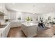 Bright, white kitchen with quartz countertops, stainless appliances, and an island with barstool seating at 491 Creevy Nw Dr, Concord, NC 28027