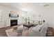 Cozy living room features a fireplace, hardwood floors, and ample seating at 491 Creevy Nw Dr, Concord, NC 28027