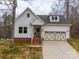 Charming two-story home featuring a white exterior, brick foundation, and a two-car front-facing garage at 5101 Thornhill Dr, Gastonia, NC 28052