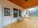 Inviting covered porch with wood ceiling, matching chairs, and a table, perfect for relaxation at 5101 Thornhill Dr, Gastonia, NC 28052