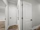 Hallway boasts wood floors and doors, offering seamless transitions between rooms with a neutral color palette at 5101 Thornhill Dr, Gastonia, NC 28052