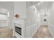 Hallway featuring a fireplace with white molding and an entrance to a kitchen with white cabinets at 5101 Thornhill Dr, Gastonia, NC 28052
