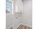 Well-lit laundry area featuring white cabinets and a window at 5101 Thornhill Dr, Gastonia, NC 28052