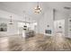 Open-concept living space with high vaulted ceilings, a kitchen island, and a fireplace feature wall at 5101 Thornhill Dr, Gastonia, NC 28052