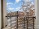 Relaxing balcony with city views, overlooking a vibrant street and mature trees at 525 E Sixth St # 208, Charlotte, NC 28202