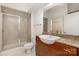 Updated bathroom with a glass shower enclosure, a spacious vanity and granite countertops at 525 E Sixth St # 208, Charlotte, NC 28202