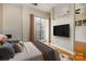 A bedroom has a sliding glass door, hardwood floors, and a neutral color palette at 525 E Sixth St # 208, Charlotte, NC 28202