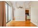 A bright bedroom features hardwood floors, sliding glass doors, and adjoins the living space at 525 E Sixth St # 208, Charlotte, NC 28202