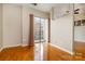 The bedroom features hardwood floors and a sliding glass door for natural light at 525 E Sixth St # 208, Charlotte, NC 28202