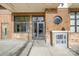 Building entrance with modern glass doors, brick facade, and clear signage at 525 E Sixth St # 208, Charlotte, NC 28202