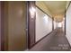 Well-lit hallway with neutral decor, leading to various units in the building at 525 E Sixth St # 208, Charlotte, NC 28202