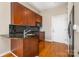 Kitchen featuring granite countertops, wooden cabinets, and hardwood floors at 525 E Sixth St # 208, Charlotte, NC 28202
