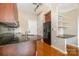 Kitchen featuring granite countertops, wooden cabinets, stainless steel appliances, and open shelving at 525 E Sixth St # 208, Charlotte, NC 28202