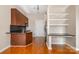 Kitchen featuring warm wood cabinets, granite countertops, and open shelving for storage at 525 E Sixth St # 208, Charlotte, NC 28202