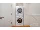 Convenient in-unit laundry with a stacked washer and dryer in a well-lit space at 525 E Sixth St # 208, Charlotte, NC 28202